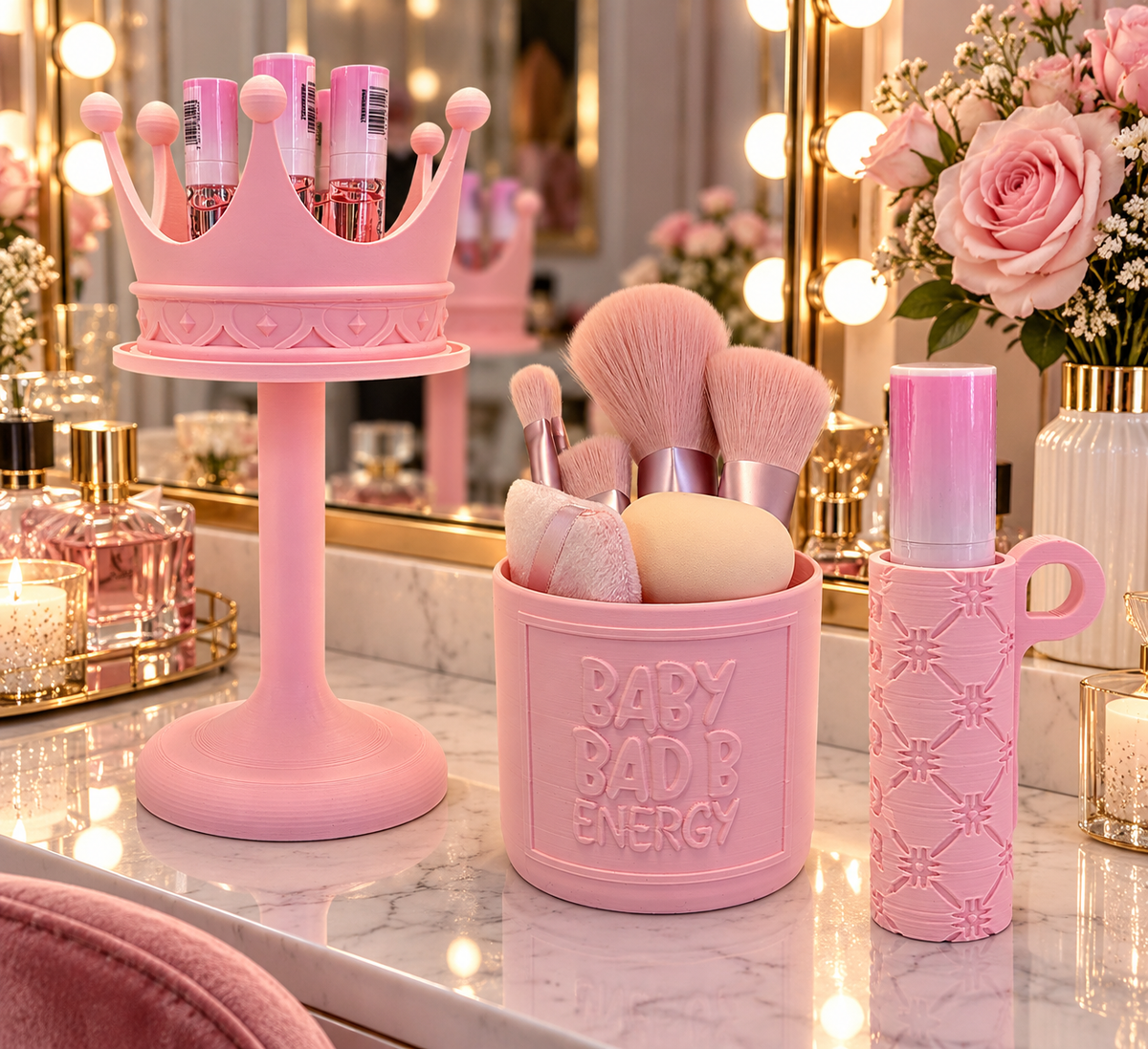 Pink dressing table accessories including crown holder, makeup brush organiser and cosmetic holder